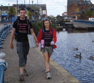 Richard Hakier and Rebecca Sellens stride through Stalybridge on the last day of their walk.